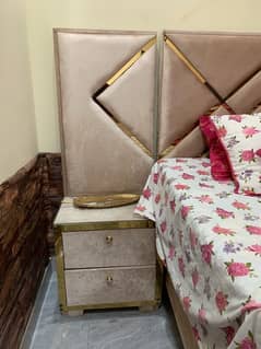 king size bed with side table and dresser