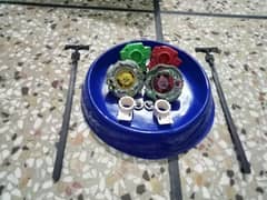 2 beyblades 2 launchers 2 nibs 1 stadium