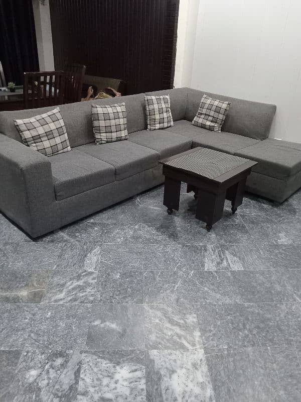 L shape sofa 7 seater. Grey colour with cushions and a table 5