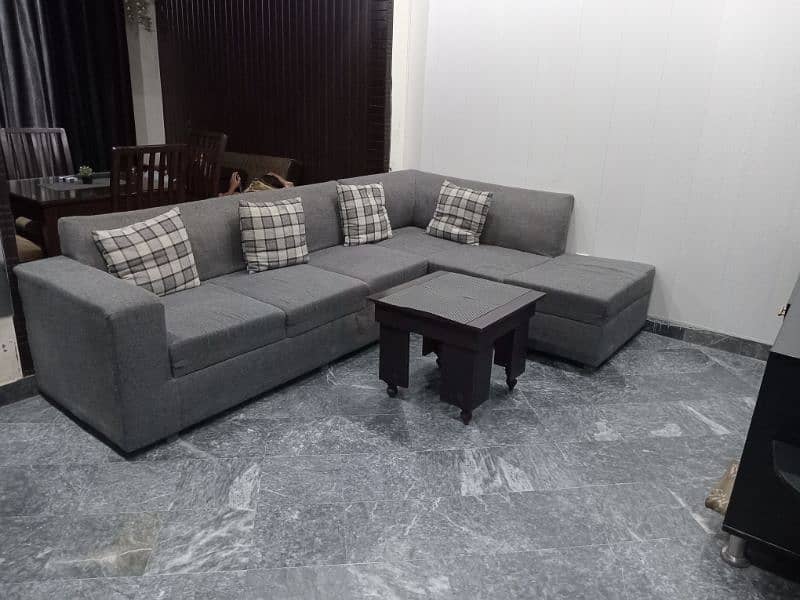 L shape sofa 7 seater. Grey colour with cushions and a table 6