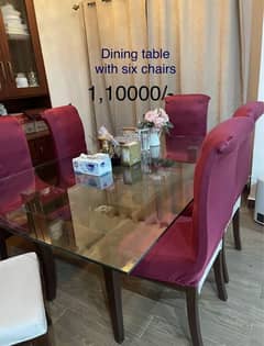 Glass top dining table with 6 offwhite chairs