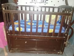 Wooden cot with mattress