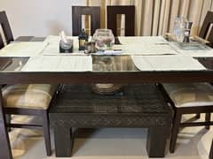 Six seater, glass top, wooden dining table.