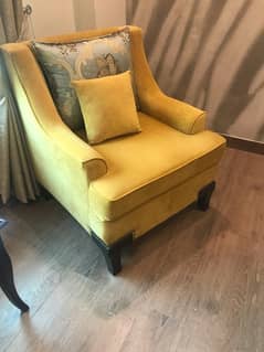 two 1 seater sofas and a small side table