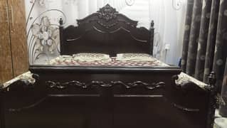 Wooden bed available with mattress.