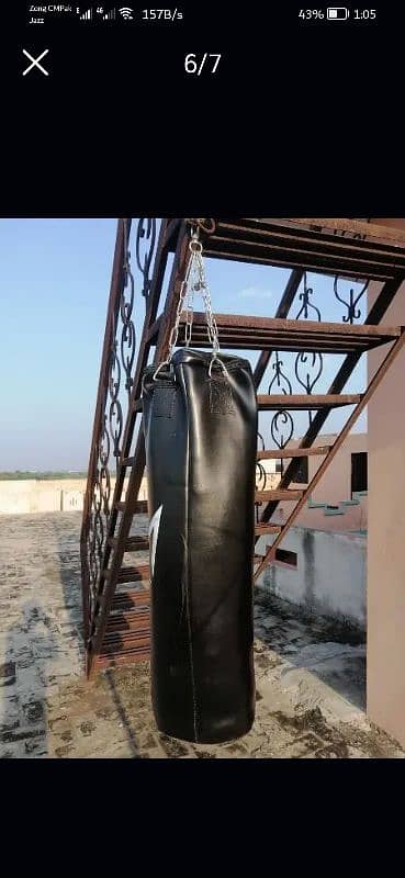 leather boxing bag with boxing gloves. 4