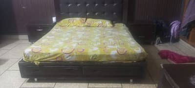 Full size Double wooden bed with side tables and sofas