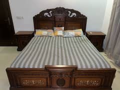 queen size bed with two side tabled