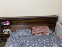 wooden bed without mattress and dressing table