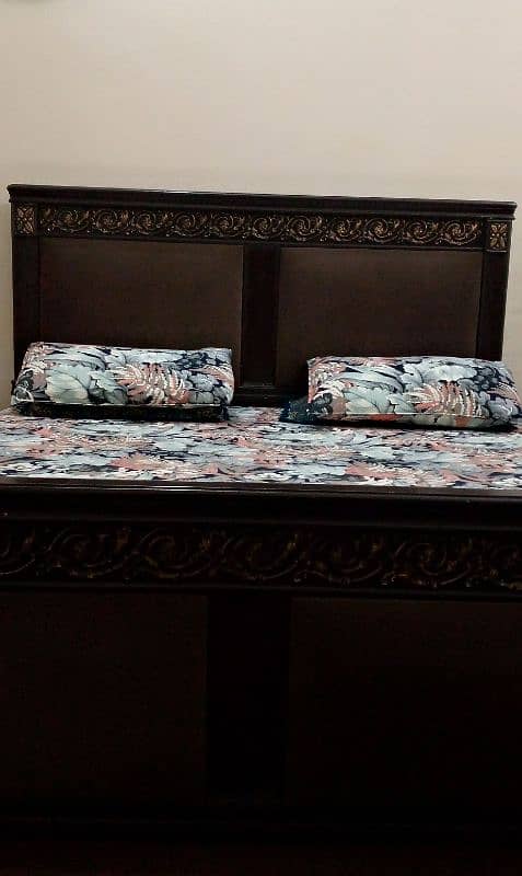 king size wooden bed to side table 0