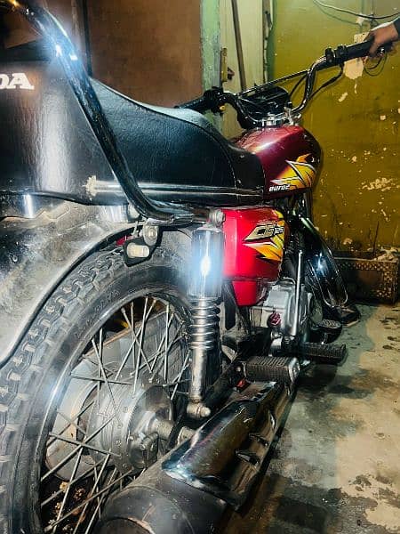 Honda 125 with Golden number 8