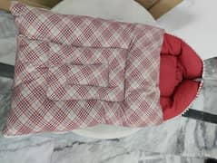 red baby seat and baby sleeping bag