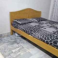 wooden bed with mattress