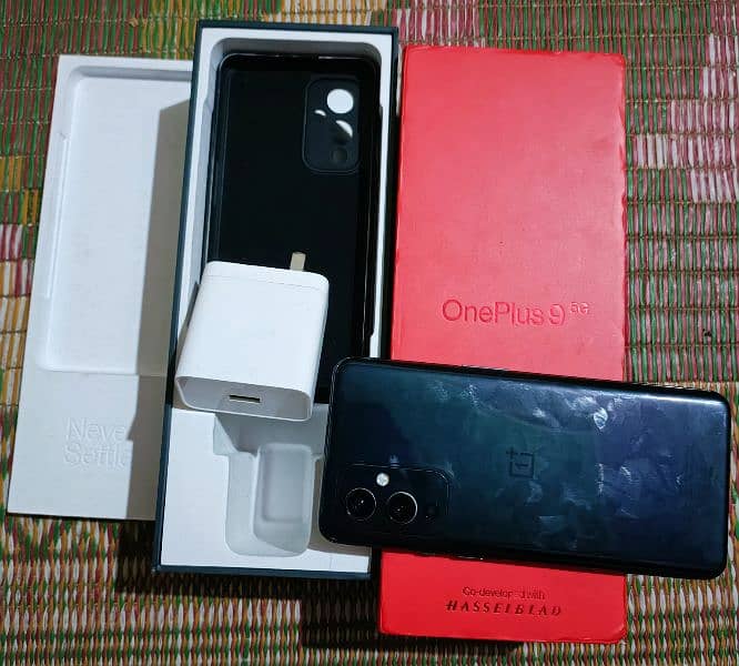 Oneplus 9 5g 12+12gb 256gb with all assesres offical pta pay tax 57k 2