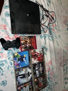 PS3 with controller and multiple CD’s