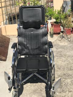 Reclining wheel chair with commode