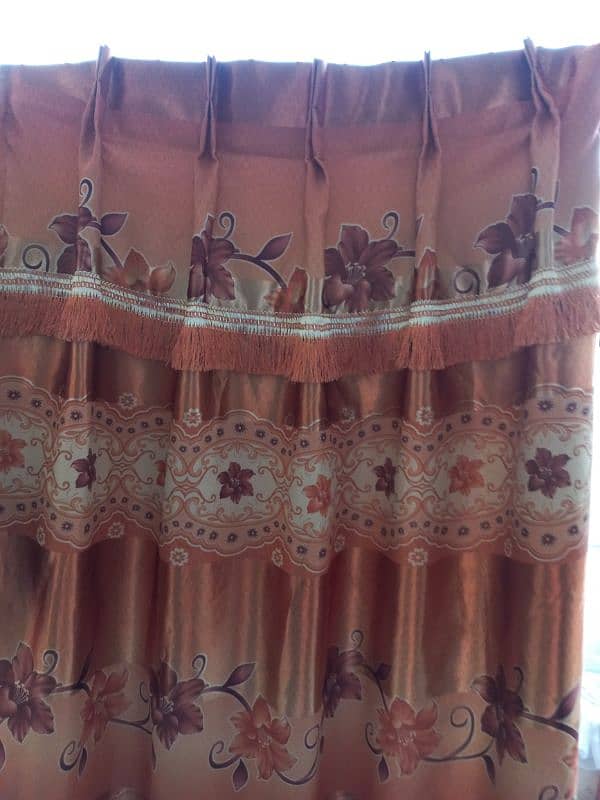 3 brown and 2 orange curtains 3