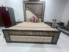 wooden bed with side tables. 0