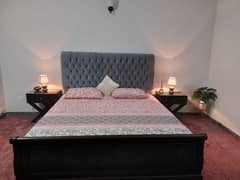 queen size bed and two side tables and dressing tables without metress