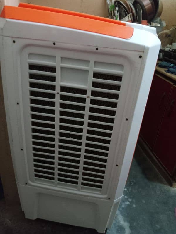 air cooler has a water tank an absorbent sheet and a fan 1