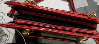 red shiny hand bag