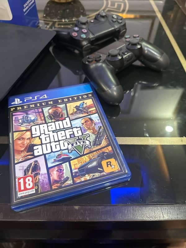 PlayStation 4 slim black colour with 2 controllers 1 gta 5 cd 2