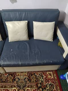 L shaped bluish grey and cream color sofa