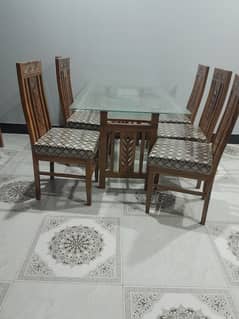 wooden dining table with glass top