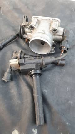 Suzuki Liana Original Throttle Body and a Coil Original Denso.