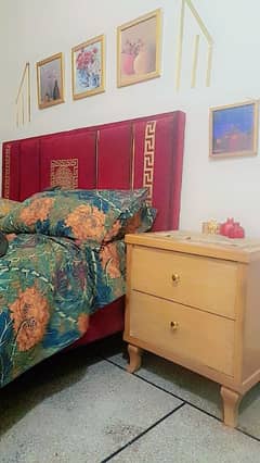 velevt mehroon bed with wooden side tables