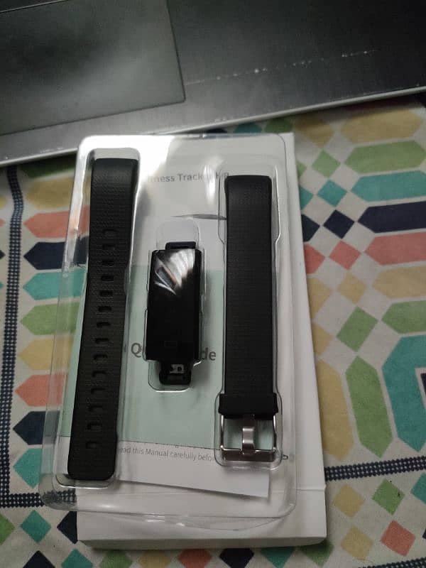 two smart watches and one fitness tracker band 1