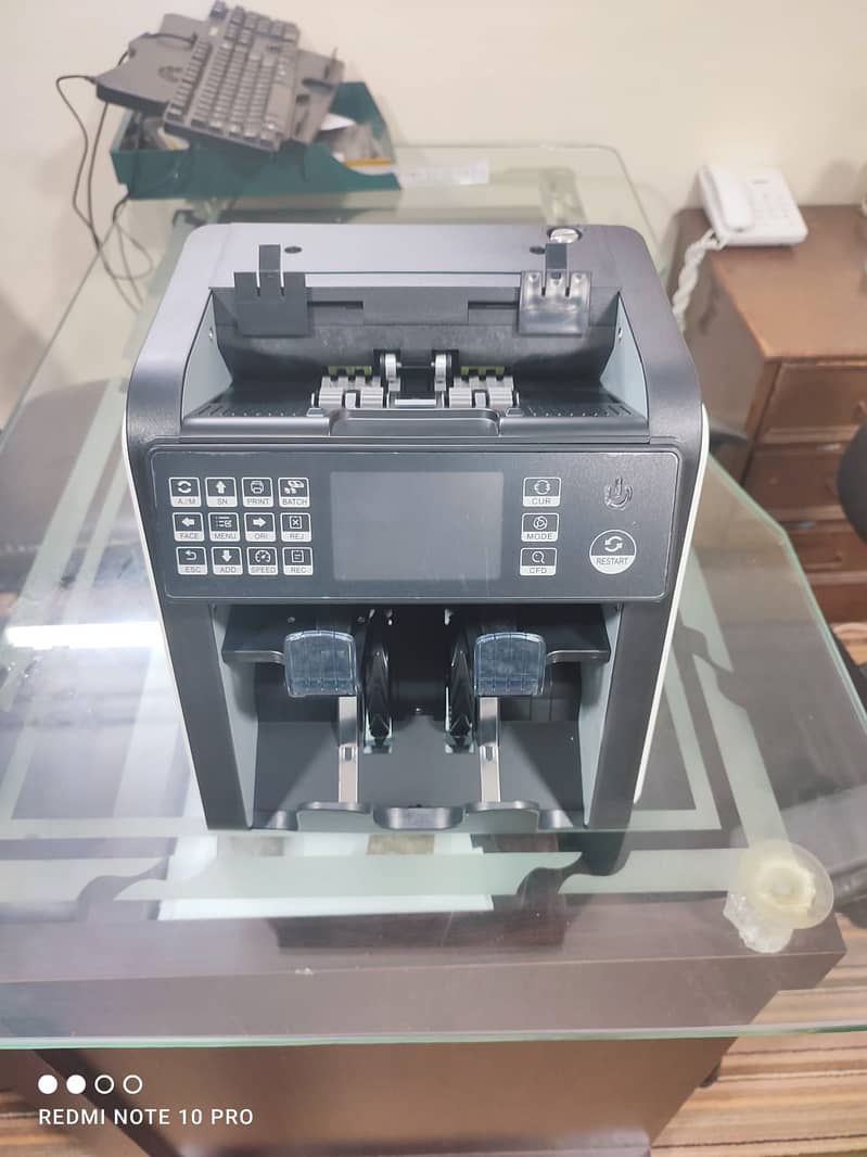 cash counting machine with fake note detection in pakistan. 14