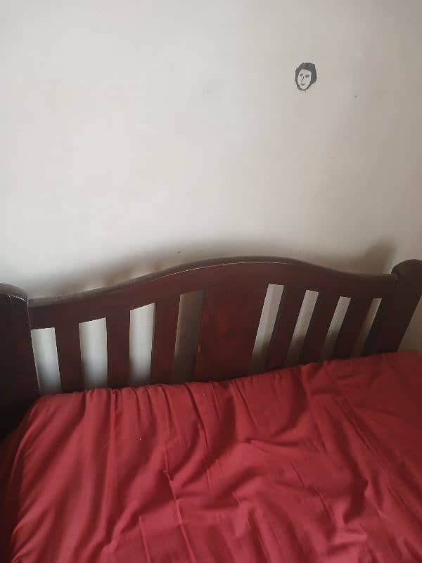 set of 2 single wooden beds. 0