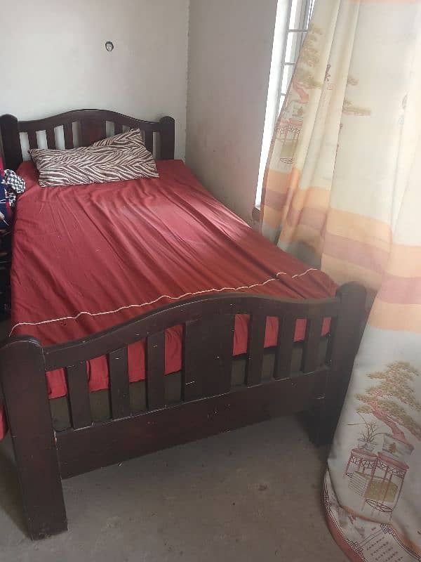 set of 2 single wooden beds. 1