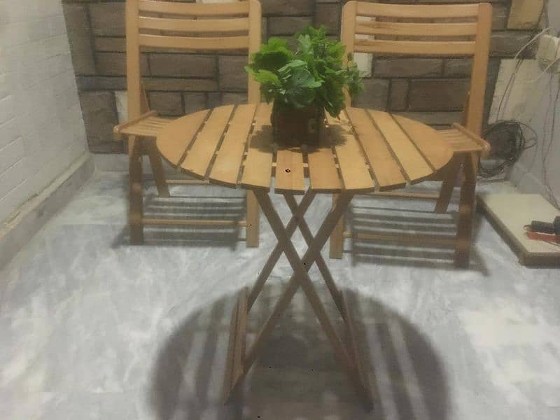 wooden table with two chairs 0