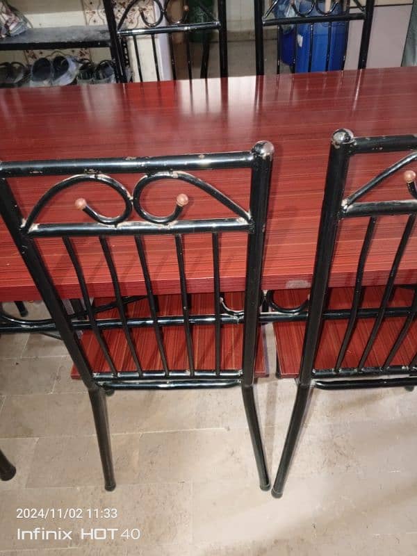 6 chair iron dining table good condition . 2