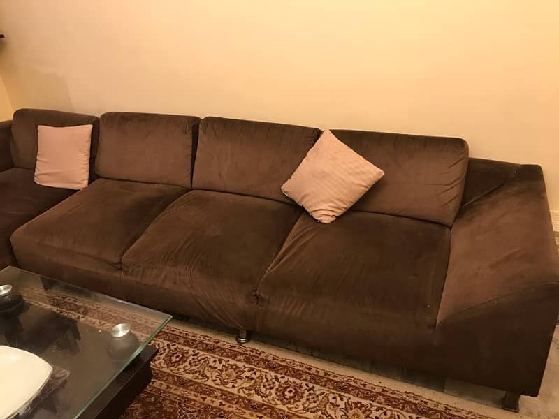 L shaped sofa with table and cushions 0