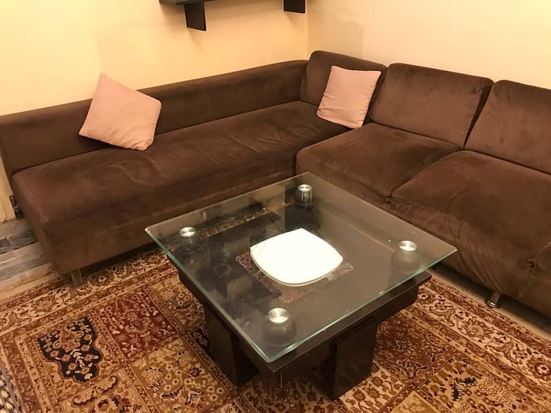 L shaped sofa with table and cushions 1