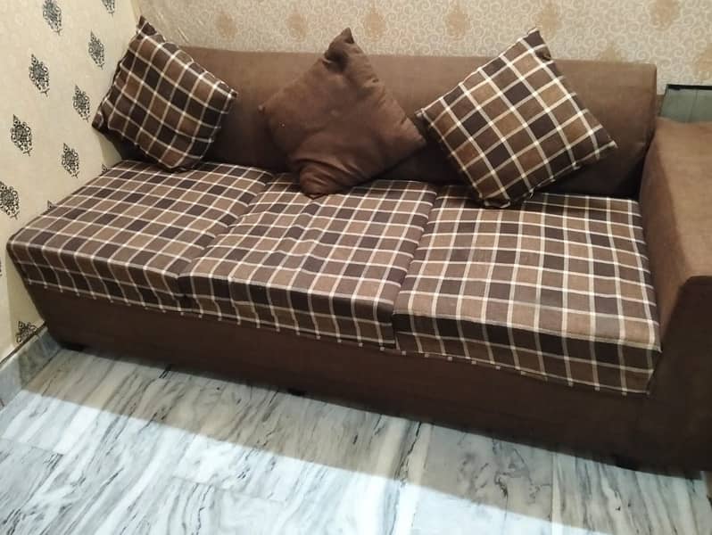 L shape sofa with 8 cusions and centre tabel 6