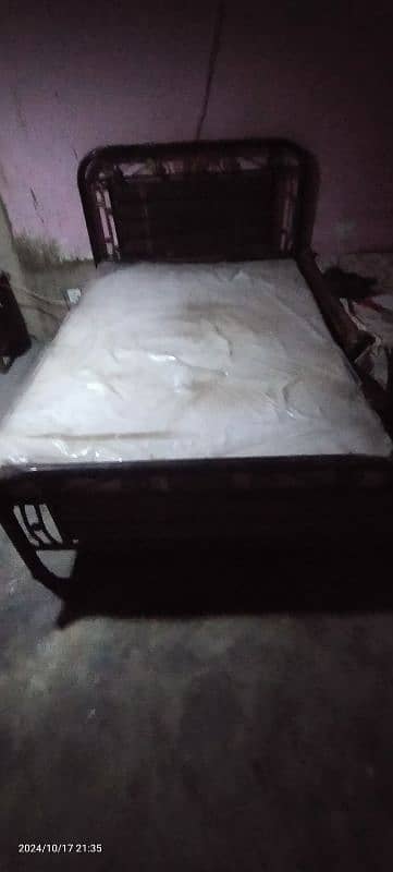 single iron bed with mattress. 6