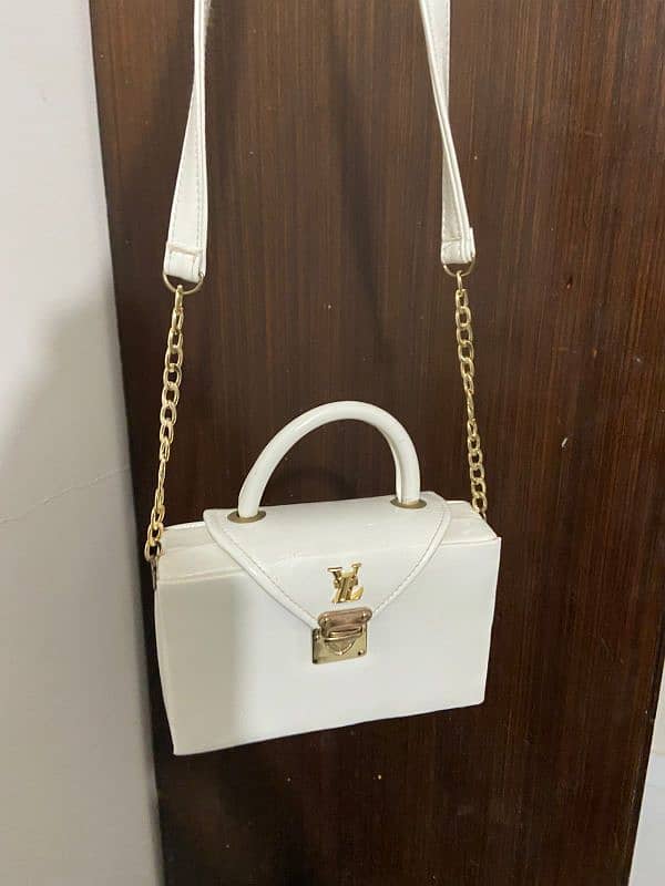 white Ysl branded bag 0