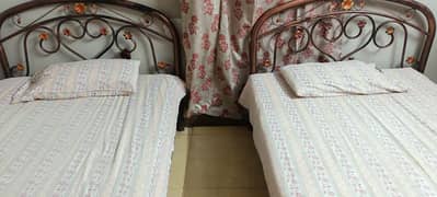 2 single iron beds without mattress