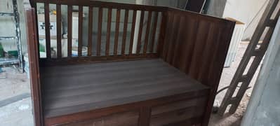 Baby cort in wooden structure with brown polish