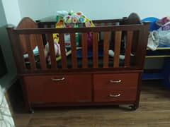 Fully wooden baby cot with lockable tyres and openable door