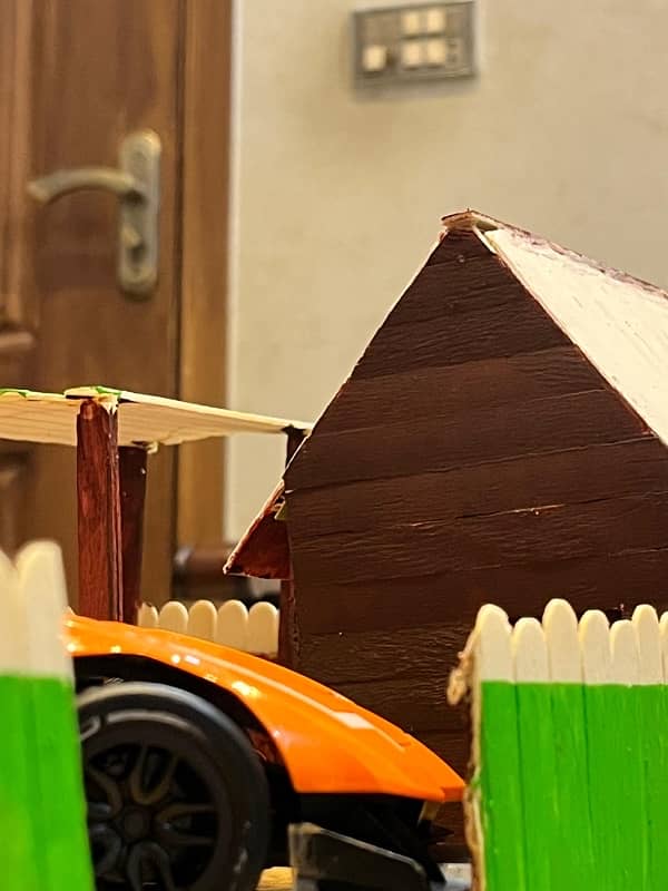 small house made from cardboard and ice sticks 3