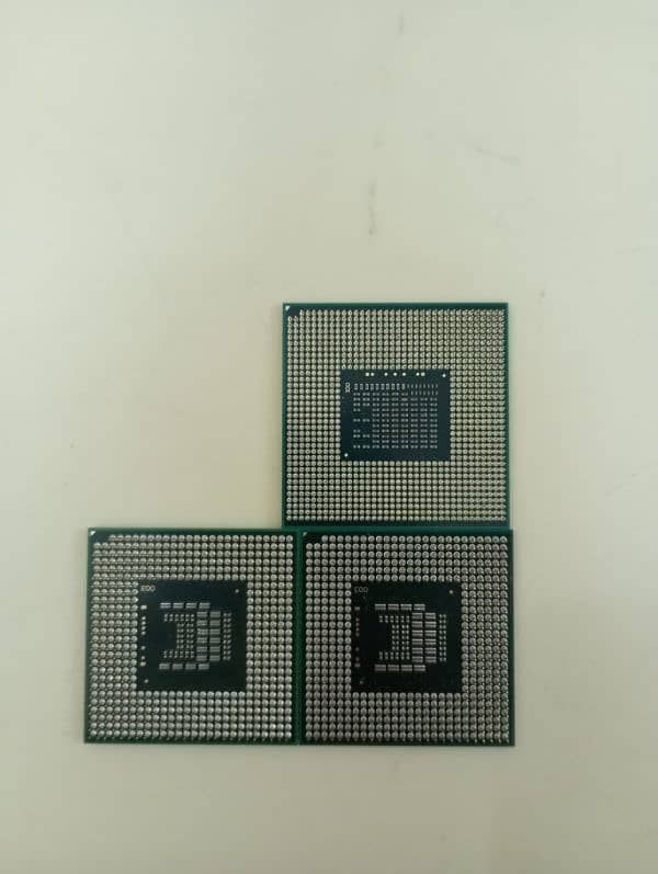 Intel core i3 2310M laptop CPU . Two Intel core 2 duo laptop CPU 1