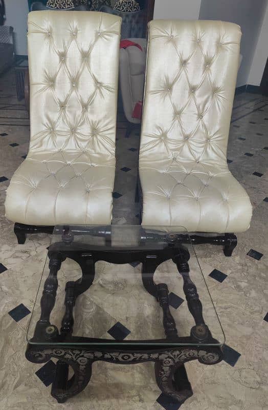 2 Hand Carved Room Chairs With A Glass Top Table. 2