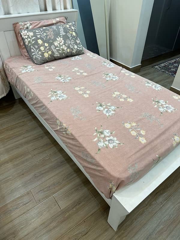 Stylish White Single Bed with Floral Bedsheet 1