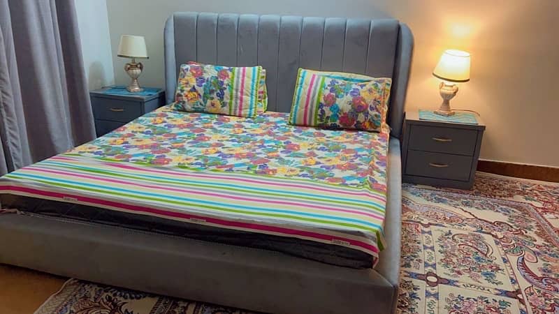 cushioned bed with side tables 1