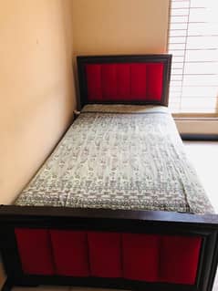 Wooden Bed with Red coutioning and spring metress